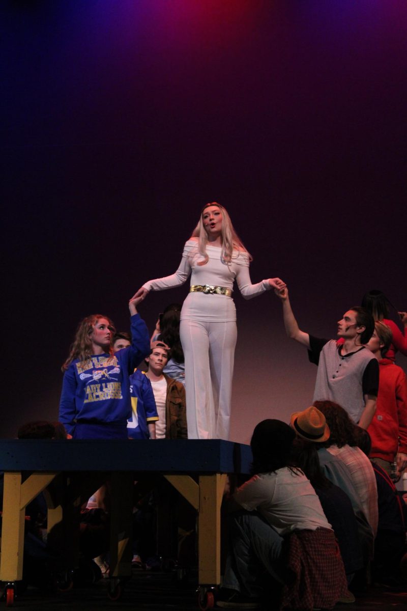 Ava Haskett and Ahren Peterson each hold Kaity Sue Stangeland’s hands while she introduces herself as Regina George in the song “Meet The Plastics”, Nov. 16, 2023. This was Haskett’s first show, and Peterson has been in previous shows “Music Man”, “The Alibis”, and “Shakespeare in Love.”