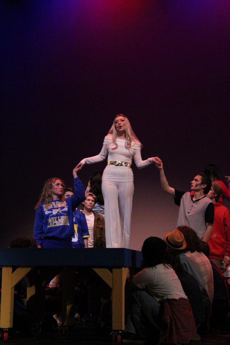 Ava Haskett and Ahren Peterson each hold Kaity Sue Stangeland’s hands while she introduces herself as Regina George in the song “Meet The Plastics”, Nov. 16, 2023. This was Haskett’s first show, and Peterson has been in previous shows “Music Man”, “The Alibi's”, and “Shakespeare in Love.”