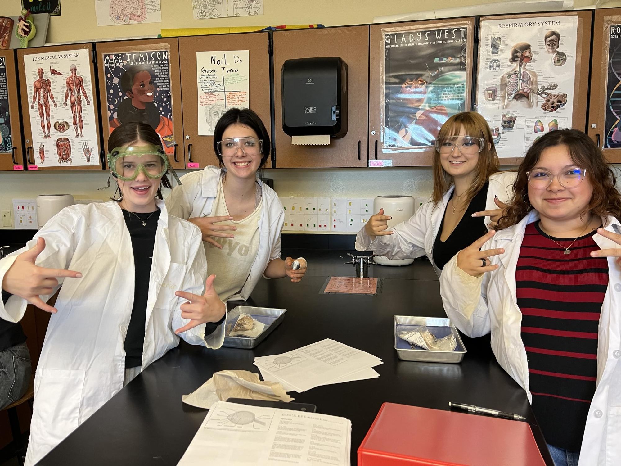 Third period HCAP students Evie Kirkpatrick, Sophia Allee, Alexis Rogers, and Hailey Arellano (left to right) take a picture before a lab dissection on cow eyeballs, September 17, 2024.