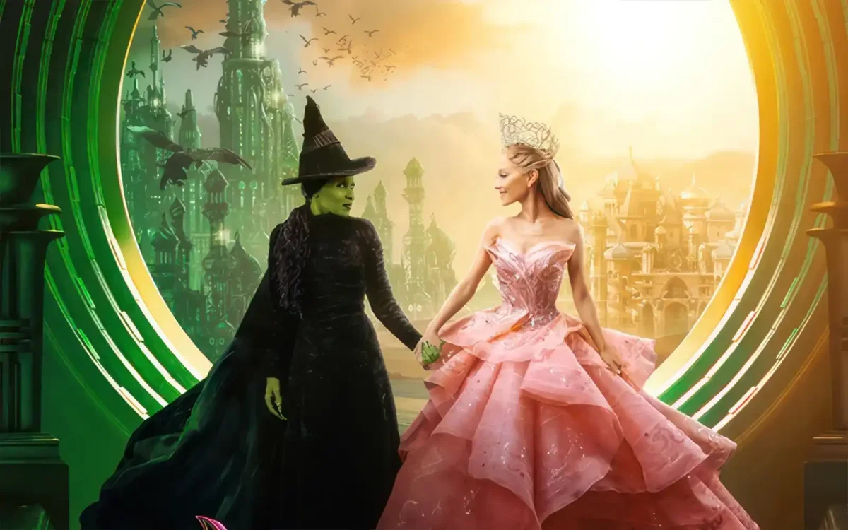 Elphaba, on the left, and Glinda, on the right, stand in front of the Palace of the Wizard. This picture is the moment when Glinda and Elphaba have to split ways. via Universal Pictures