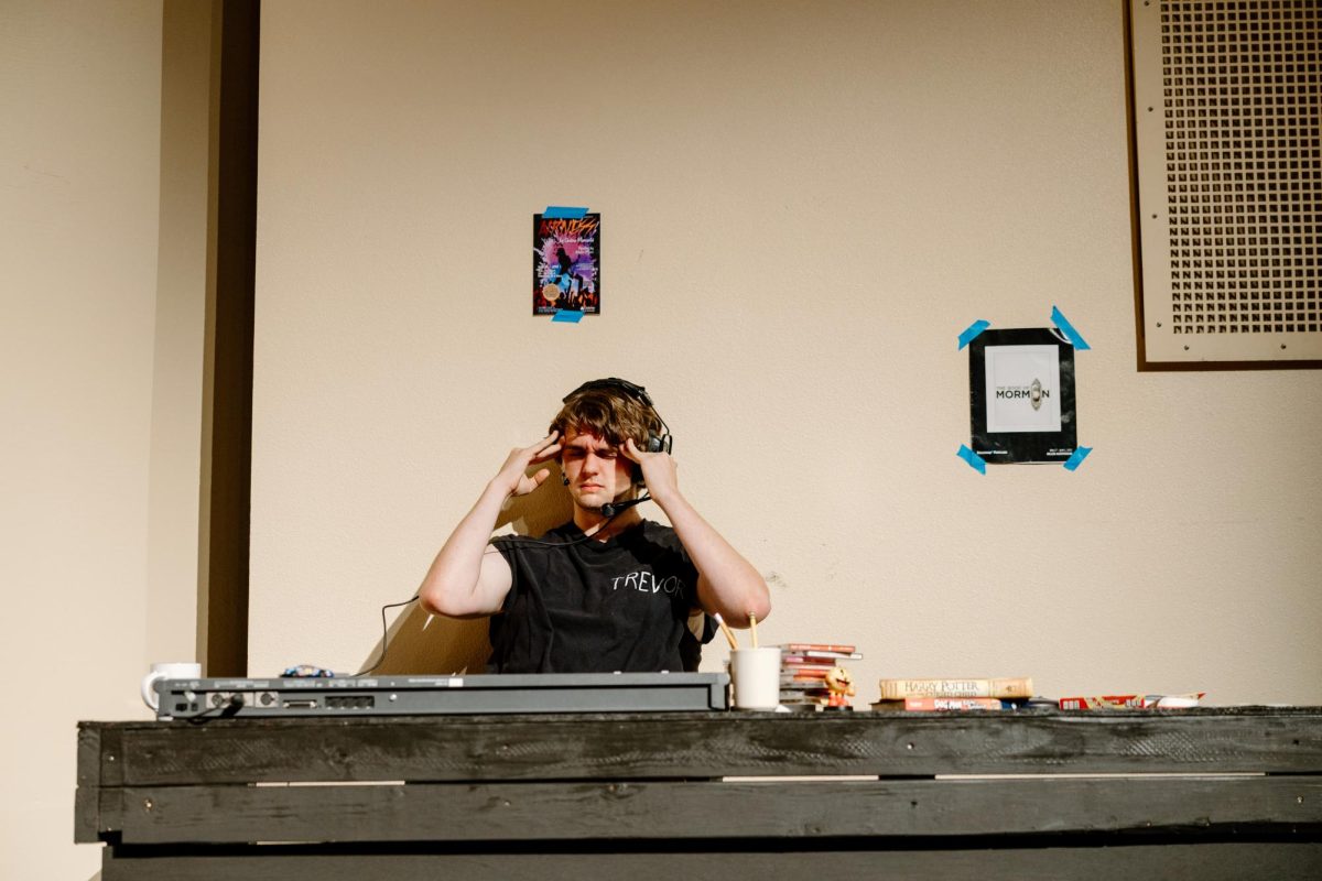 Jonathan Newman is a junior at OCHS and is seen here portraying the role of Trevor in The Play That Goes Wrong. At this moment, Trevor is in his tech booth, very annoyed with the shenanigans happening onstage that he has to put up with.