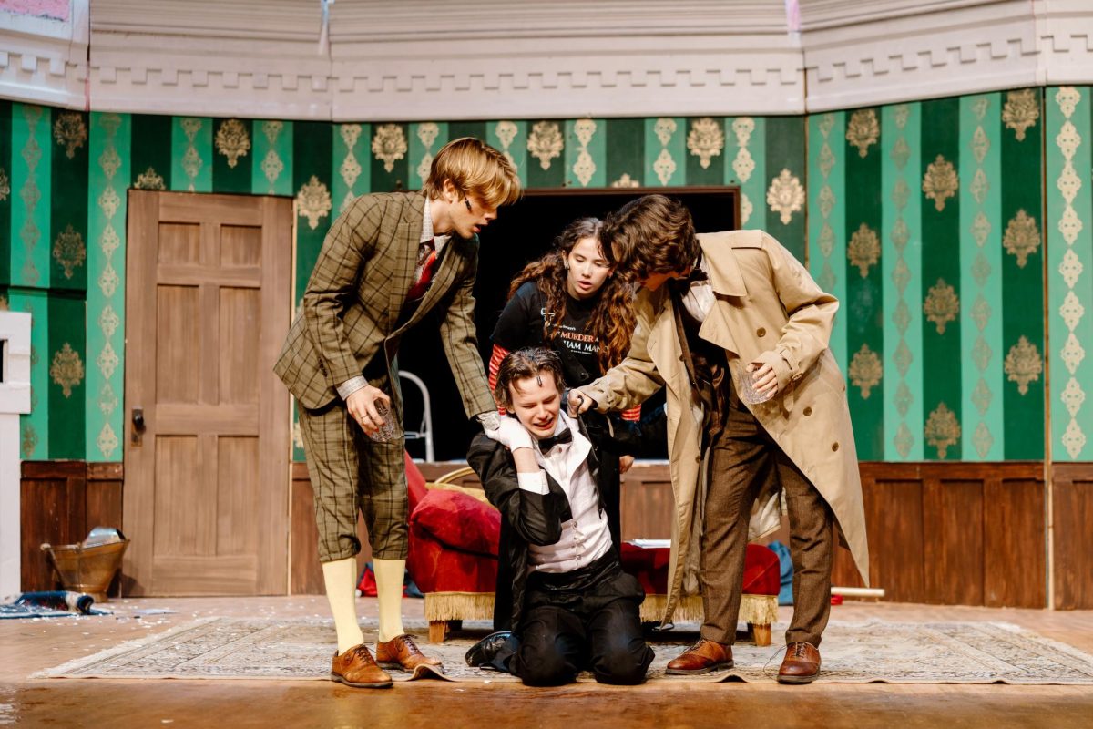 Here in this hilarious scene, we have Liam Dale as Robert, Austin Wessel as Dennis, Cambria Rich as Annie, and Brennan Nazaretta as Chris. Their characters have been stuck in a loop as Dennis (Wessel) seems to have forgotten his line that transitions The Play That Goes Wrong into the second act. Everyone is quite eager to move on from this scene, but they must wait for Dennis to say the right line.