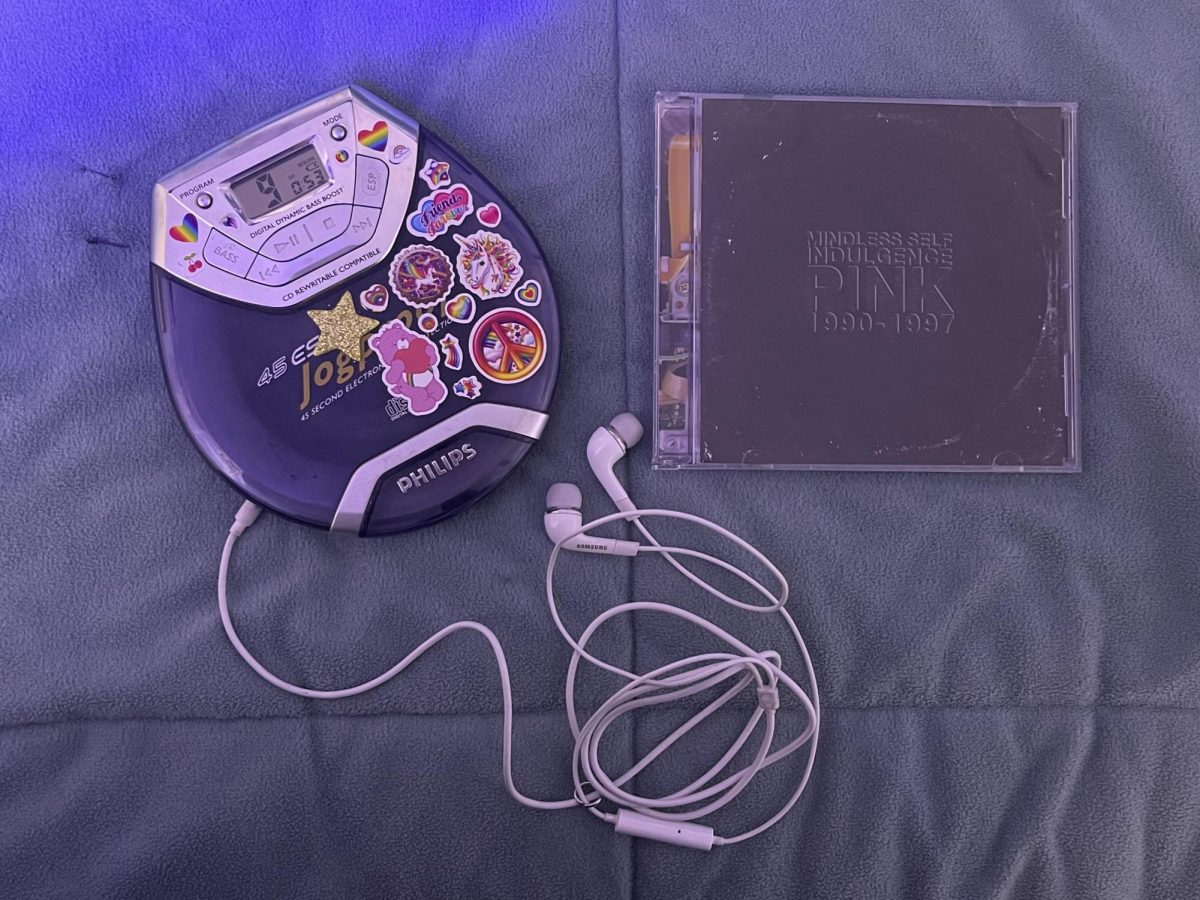 Kennith. M's CD copy of the PINK album with his potable CD player on track 9, "Envy". This photo was taken on February 18th 2026.